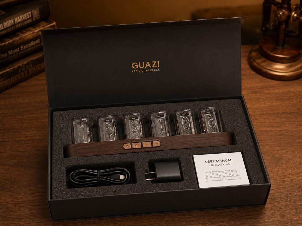 GUAZI gift box open - clock, USB cable, adapter, and manual arranged neatly